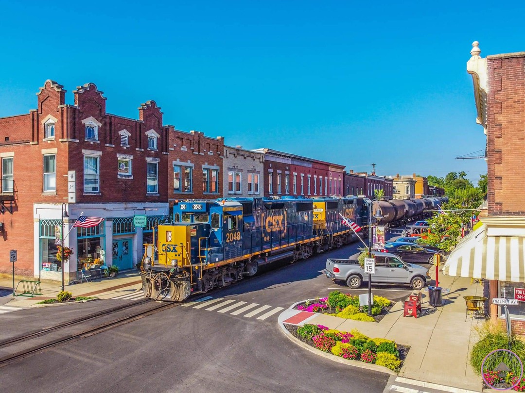 Historic small town main street with train passing through downtown shopping district